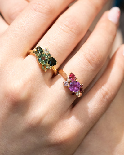 Cocktail Cluster Ring featuring sapphires, diamonds and rubies in different fancy cuts and round brilliant cut.
