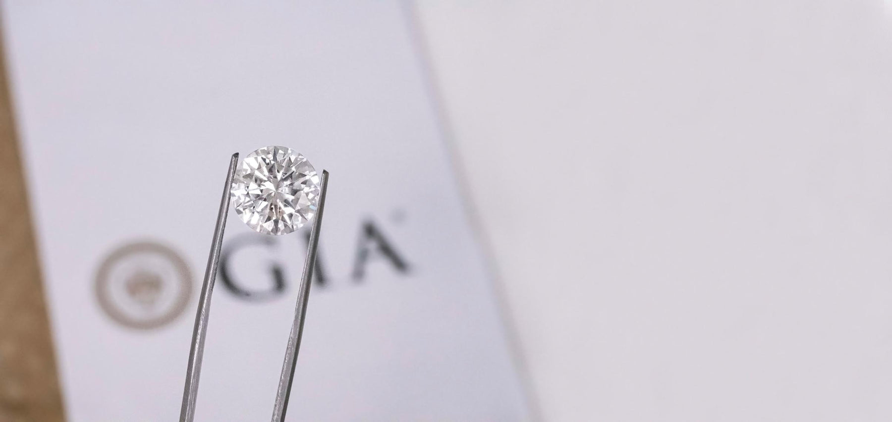GIA certified diamond, round brilliant cut diamonds, Certified diamond, diamond held by tweezers, The Four C's 