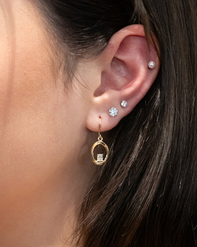 Mobius Twist Oval Cut Diamond Drop Earrings paired with Floeting® Diamond Stud Earrings