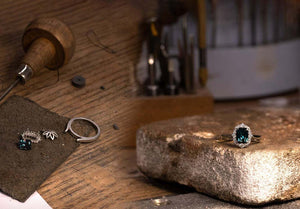 jewellers bench, teal sapphire ring, diamond halo ring on bench, ring assembly, making engagement ring 