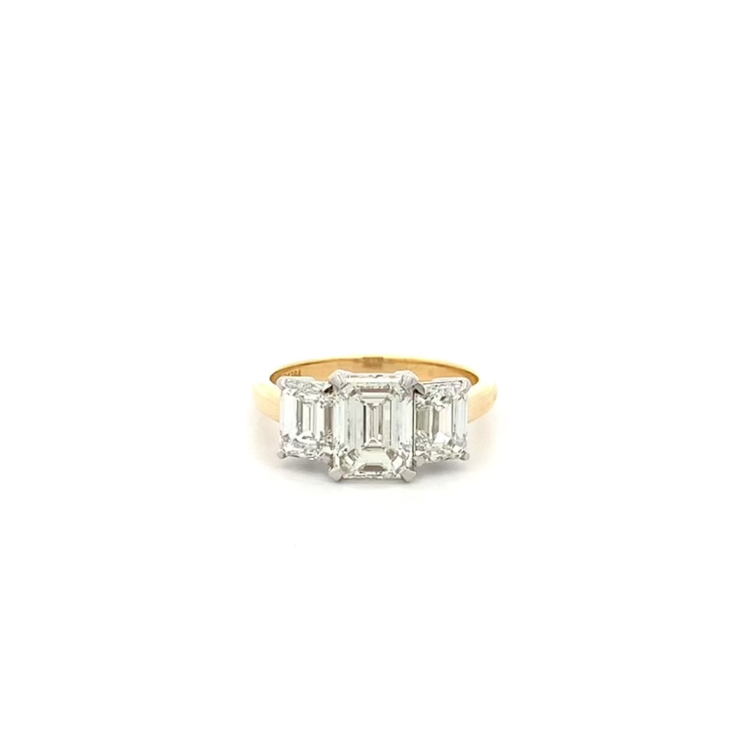 Erté: Emerald Cut Diamond Three Stone Ring in Yellow Gold | 4.04ctw