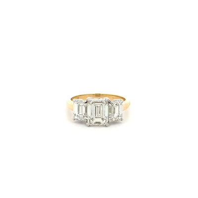 Erté: Emerald Cut Diamond Three Stone Ring